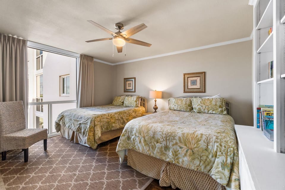 Unwind in your bright twin-bed retreat with tropical touches, ceiling fan comfort, and peaceful street views.