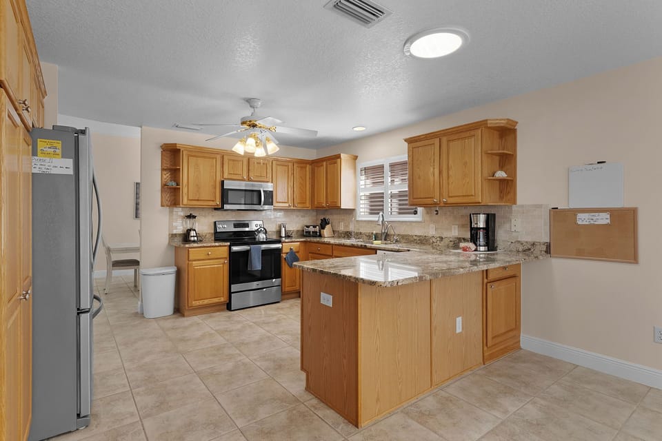 Your fully equipped kitchen features granite countertops, stainless steel appliances, and an island perfect for meal prep and casual dining.