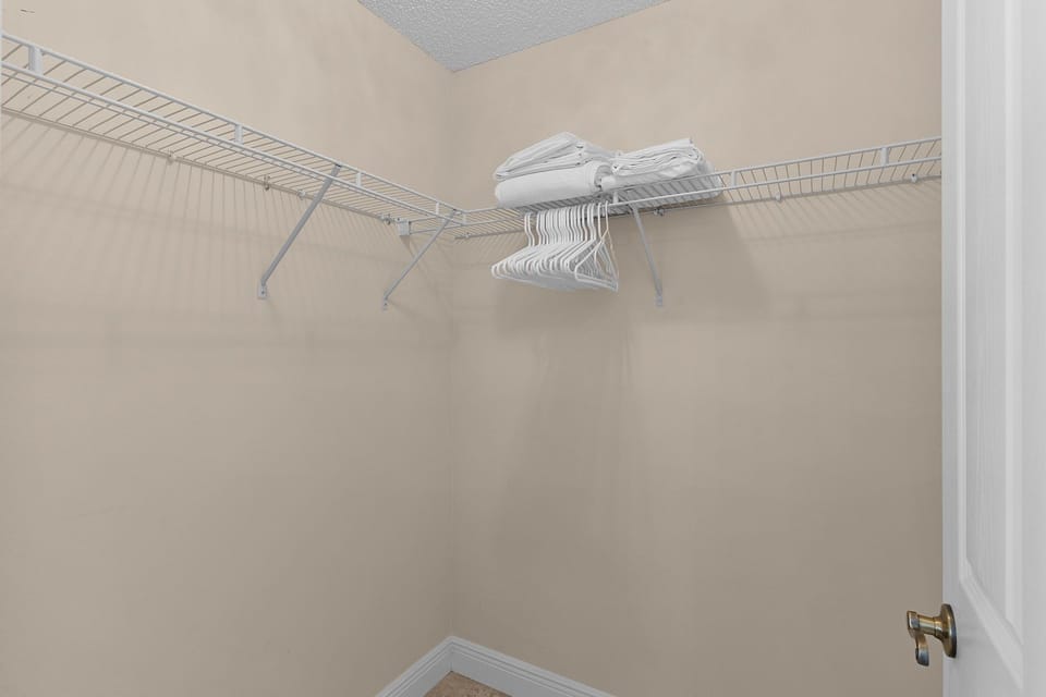 Your spacious walk-in closet features wire shelving and hangers, giving you plenty of room to organize your belongings during your stay.
