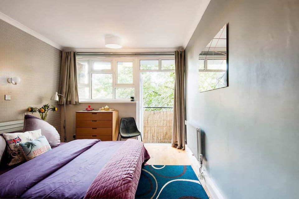 Bedroom Bliss: Bright and airy retreat with lush views and stylish decor for restful nights!