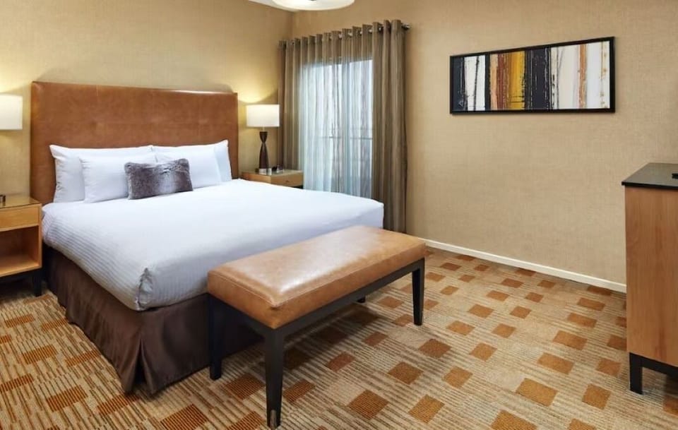 Unwind on crisp linens in a calm, cozy room.