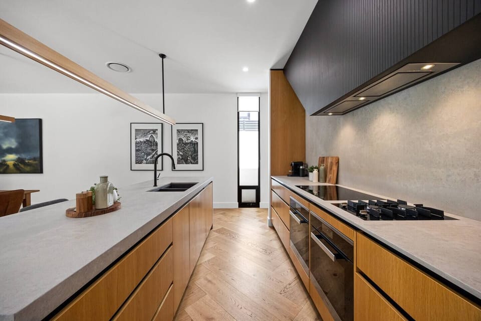 Prepare meals in the fully equipped kitchen, complete with premium appliances, everyday essentials and generous bench space.