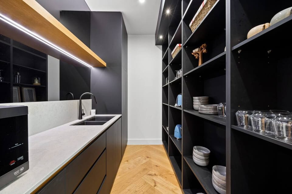 A well-equipped butler’s pantry keeps everything within easy reach for effortless cooking.