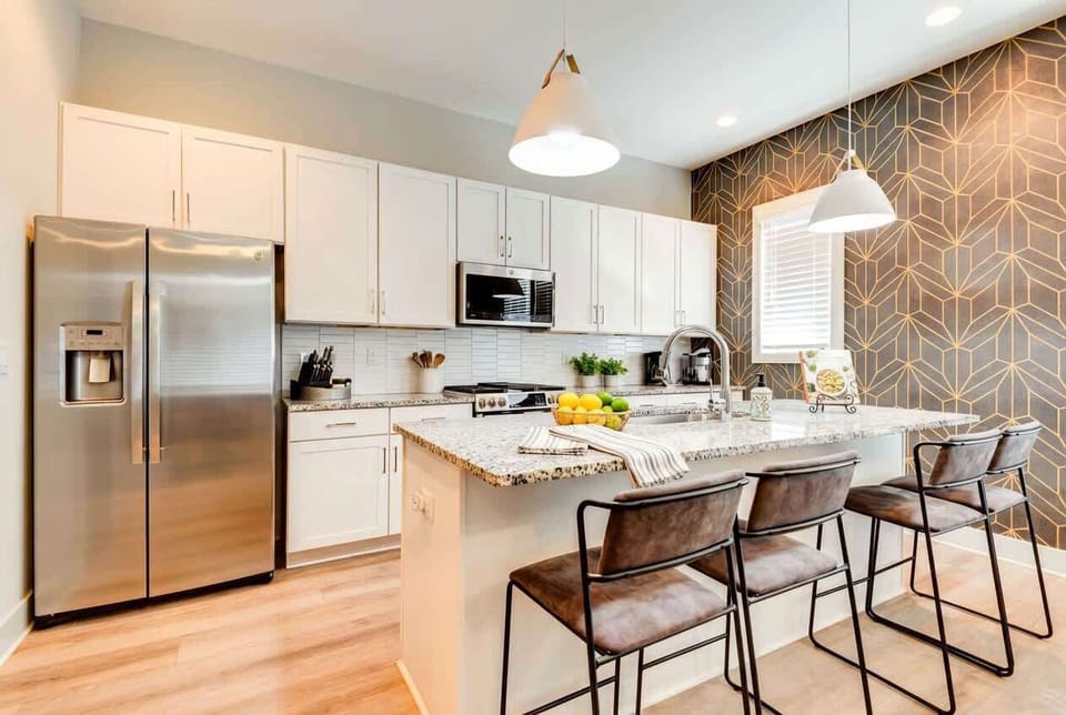 Island with bar stools keeps everyone circled up while food comes together, perfect for group dinners or late-night snacks
