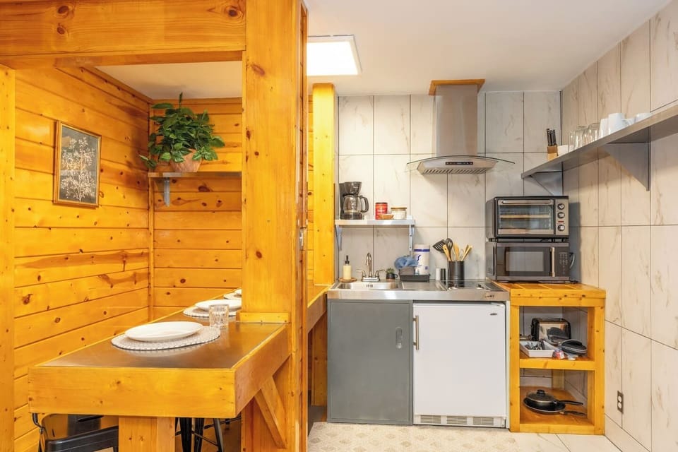 - Fully equipped kitchenette with mini fridge, microwave and sink - Rustic wood breakfast bar seating for four and open shelving - Perfect tiny cabin stay for couples seeking comfort and convenience