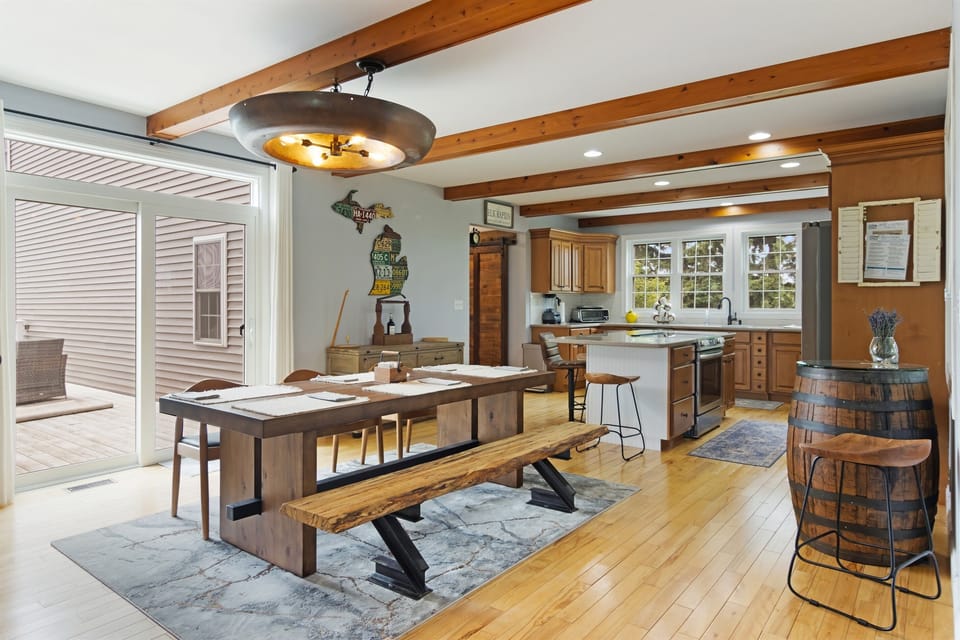 Large farmhouse table, open kitchen, perfect for group meals.