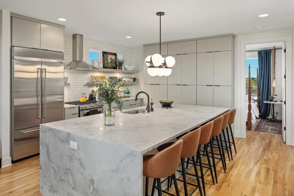 Welcome to this stylish Nashville kitchen! With elegant finishes and spacious countertops, it's perfect for gourmet dinners and casual brunches. Gather around the island and create memories in this luxury vacation rental in Music City!