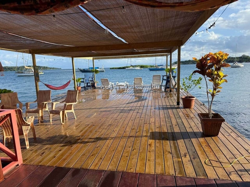 Lower deck with hammocks, chairs, games, and sun shades.