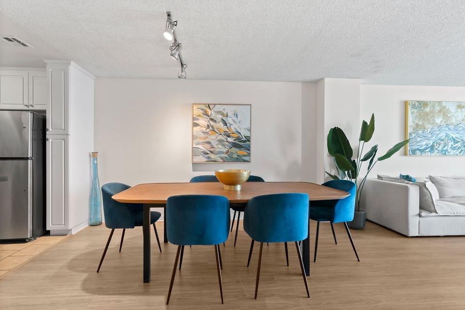 Dine in style with vibrant velvet seating and a modern, open-concept layout.