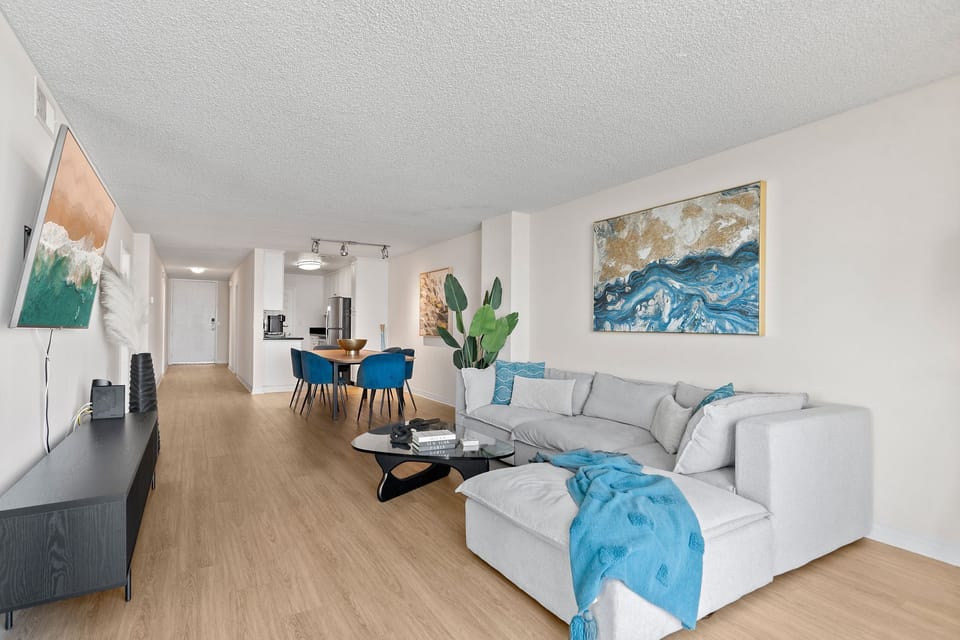 Relax in a spacious, light-filled living area featuring modern designer decor.