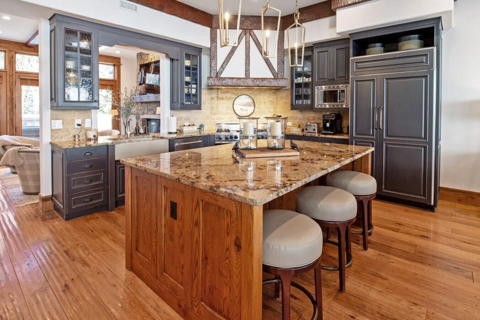 The gourmet kitchen comes fully equipped, expansive island, quality cookware, dishes, silverware, coffee station, and full-size refrigerator/freezer. Everything you need to cook family meals or après-ski snacks. The hearth room just beyond for fireside re