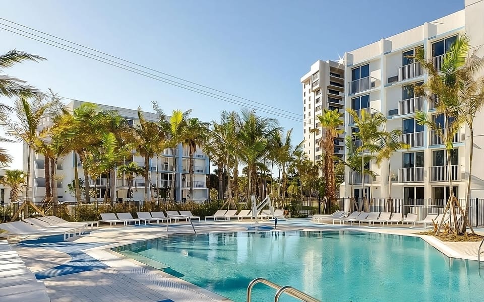 Unwind poolside with swaying palms and sparkling blue water.