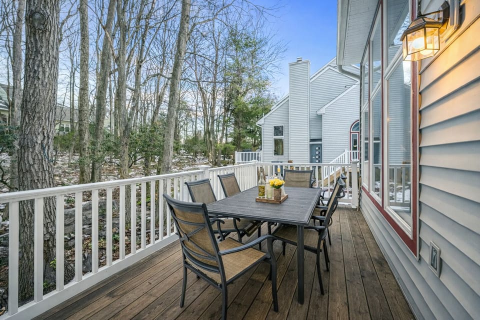 A private deck set among the trees, offering peaceful outdoor dining and fresh mountain air year-round.