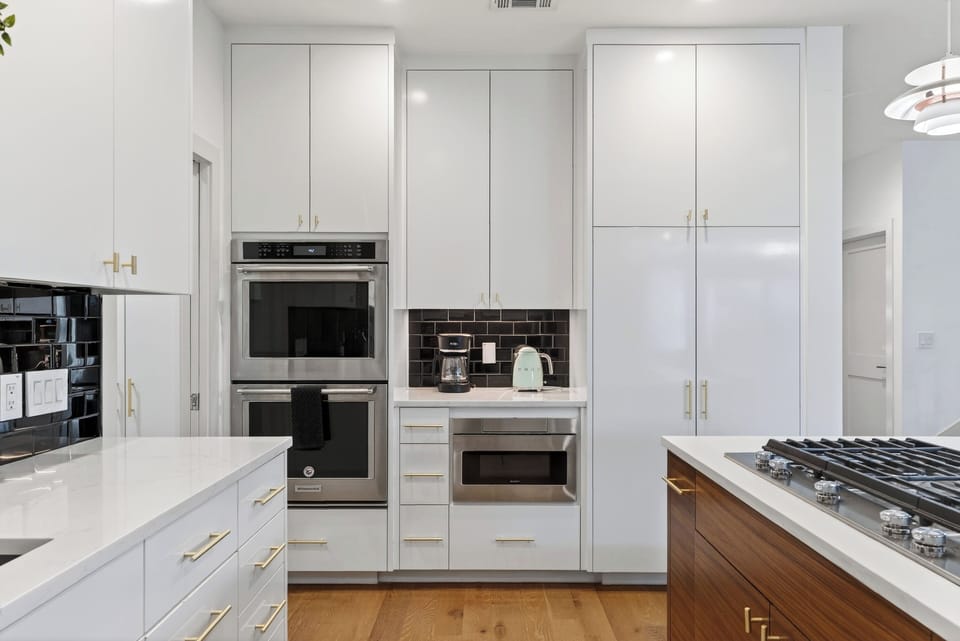 Sleek chef’s kitchen with a spacious island, modern appliances, and stylish pendant lighting.