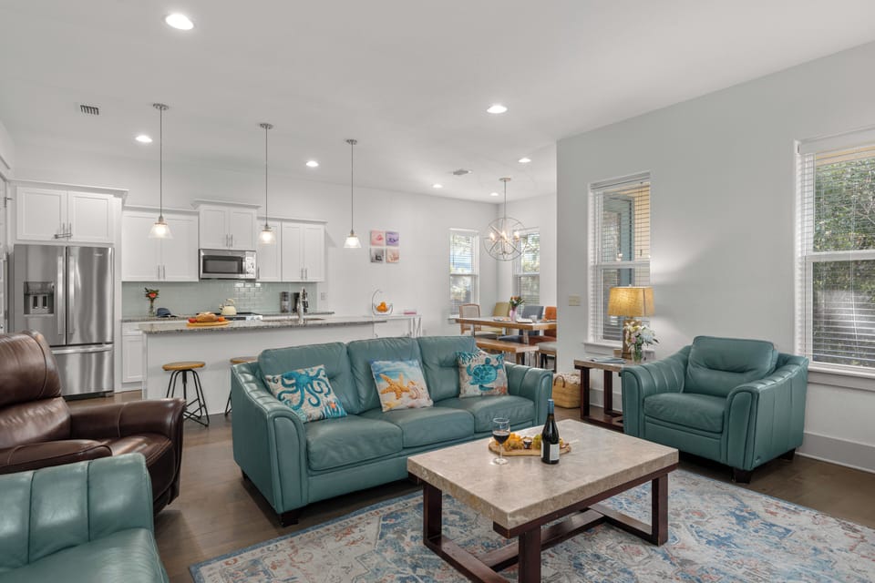 Bright living room with ample seating and a large TV—perfect for movie nights.