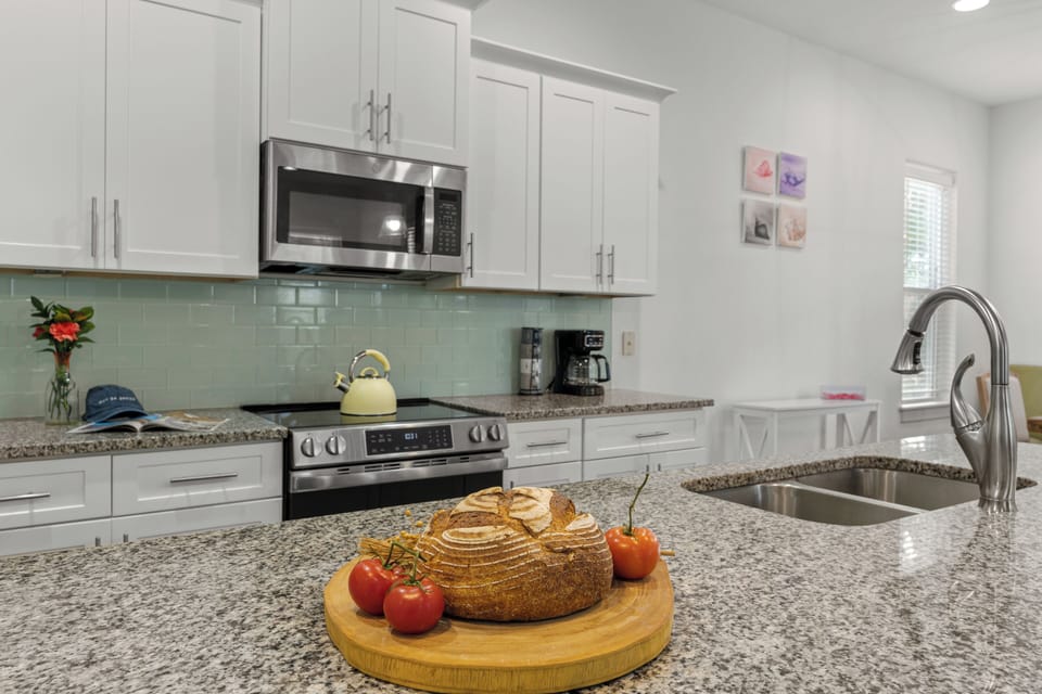 Modern, open-concept kitchen with stainless steel appliances and a spacious island with seating.