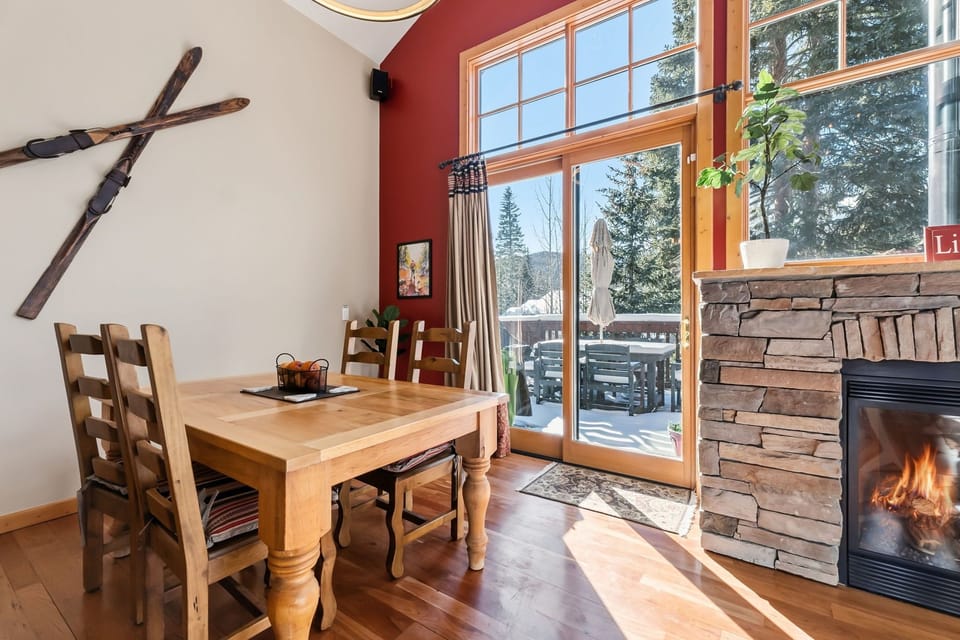 Gather around your rustic dining table beside the crackling fireplace, with mountain views framing memorable meals in this cozy alpine retreat.