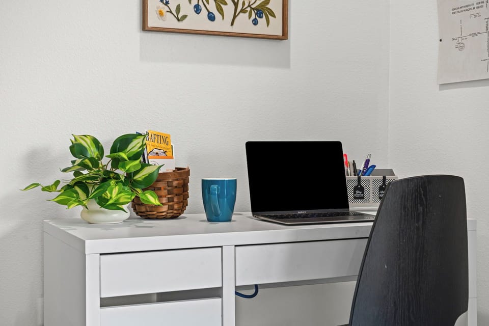 Your dedicated workspace combines style and function, featuring a sleek white desk with storage and comfortable chair for productive days.