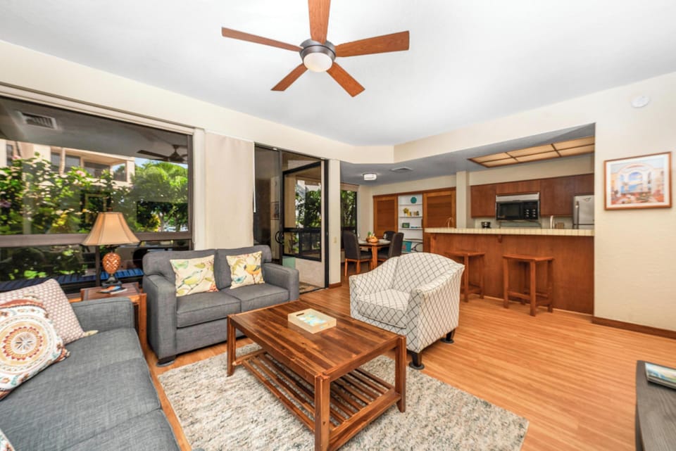 Unwind in your spacious open-plan living area where warm wood tones and modern comfort create the perfect island retreat atmosphere.