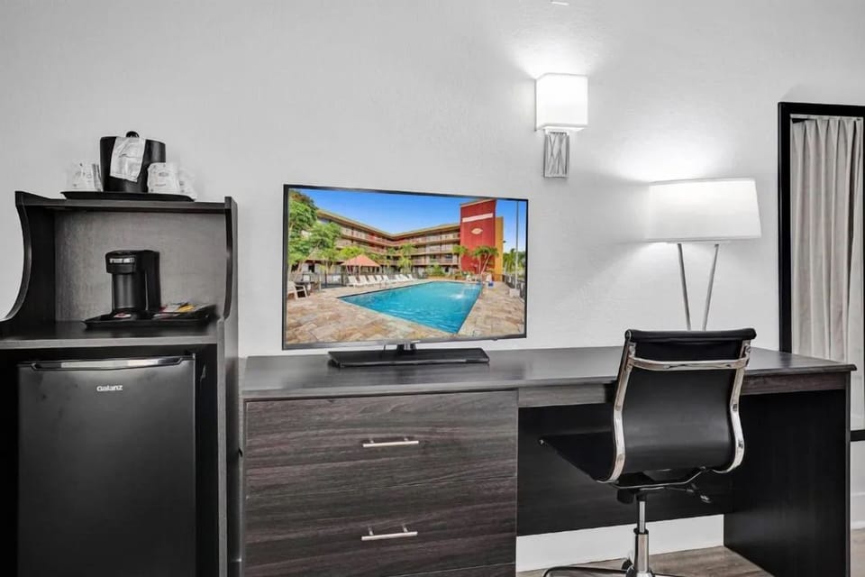 Recharge with a roomy desk, TV, and in-room refreshments.