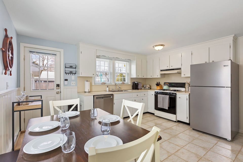 Full kitchen, dining for 3 and backyard access.