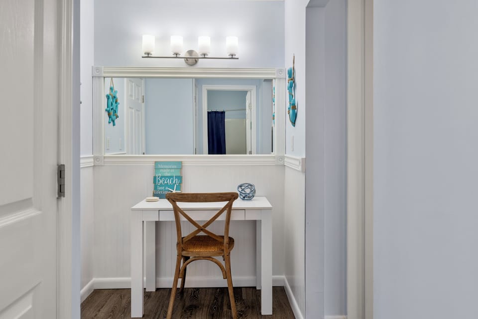 Your private vanity nook awaits with beach-inspired charm and perfect lighting for getting ready.