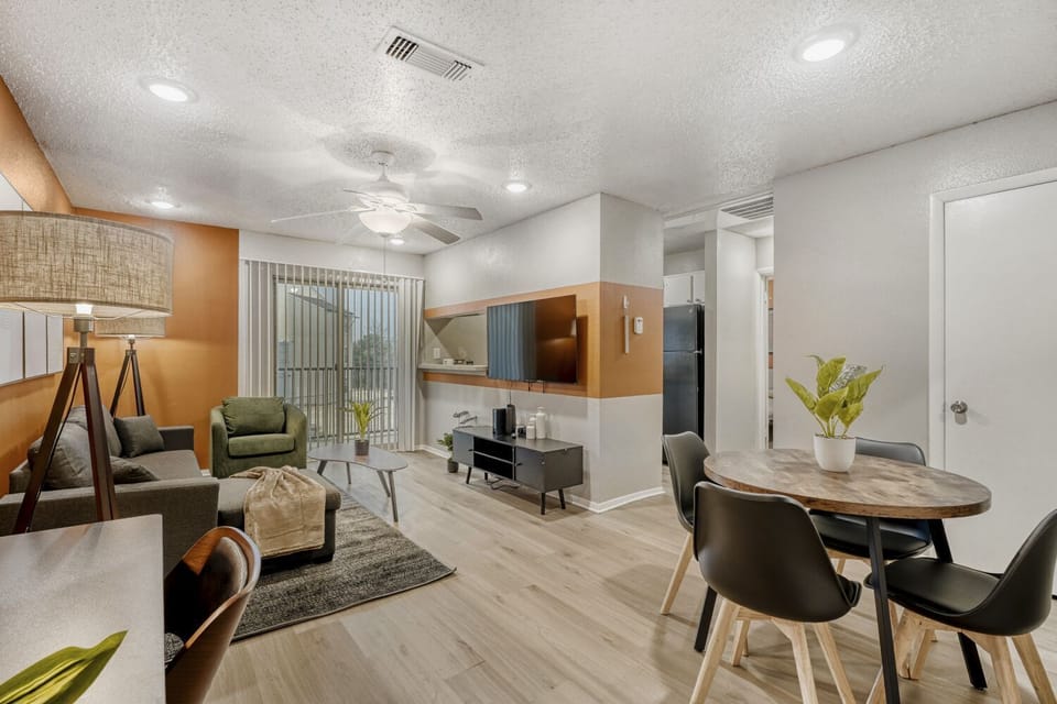 Warm, cozy living space with comfortable seating and a dining area