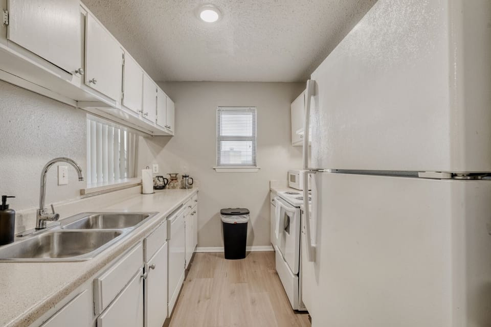 Bright and spotless kitchen with full amenities.
