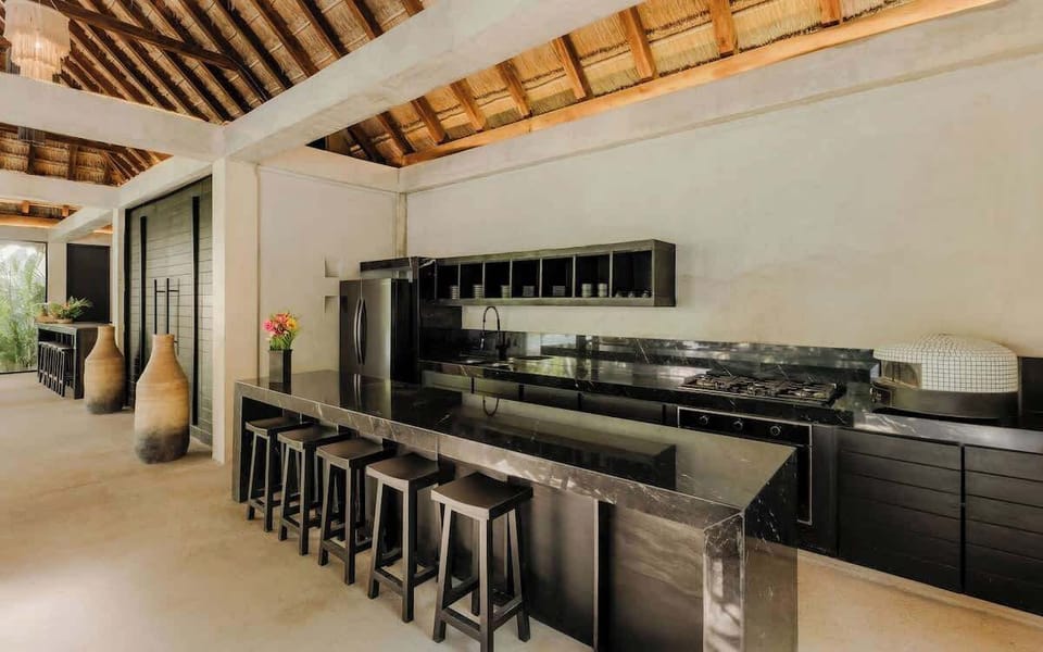 Bar seating and pro-grade appliances — the kitchen works as hard as you play.