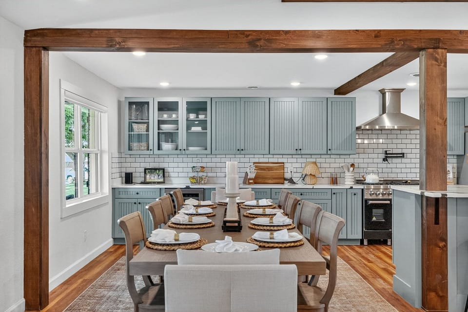 Spacious farmhouse kitchen with 10-seat table and chef’s range
