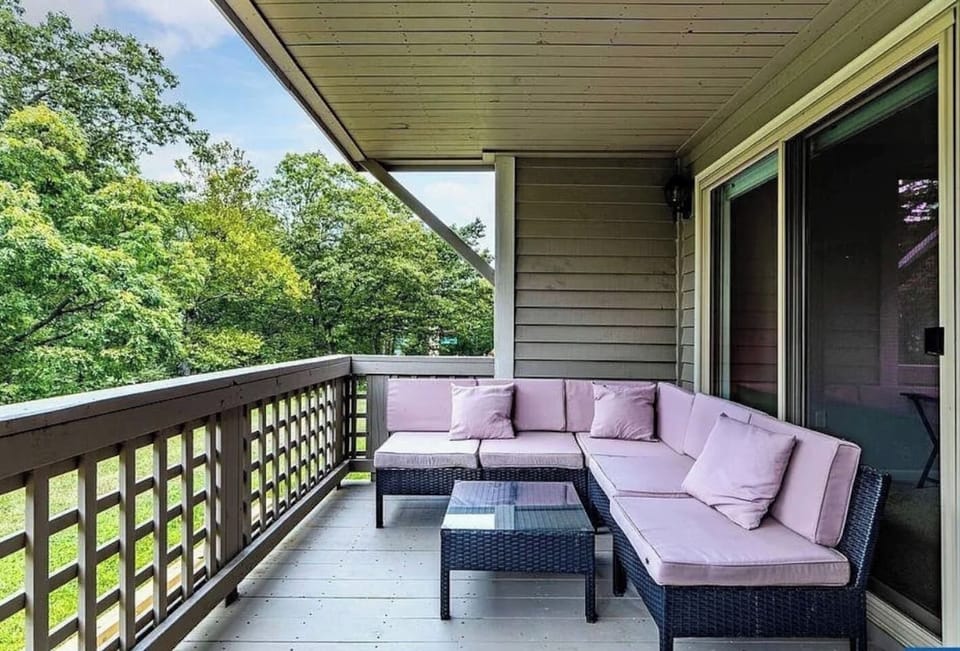 Balcony Retreat: Unwind on the stylish sectional with nature views and fresh mountain air!