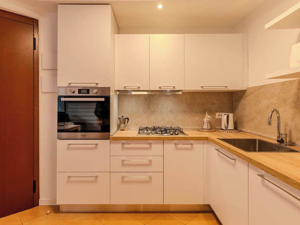 Kitchen, Kitchen Appliance, Countertop, Major Appliance, Cabinetry, Flooring, Wood, Interior Design, Stove, Furniture