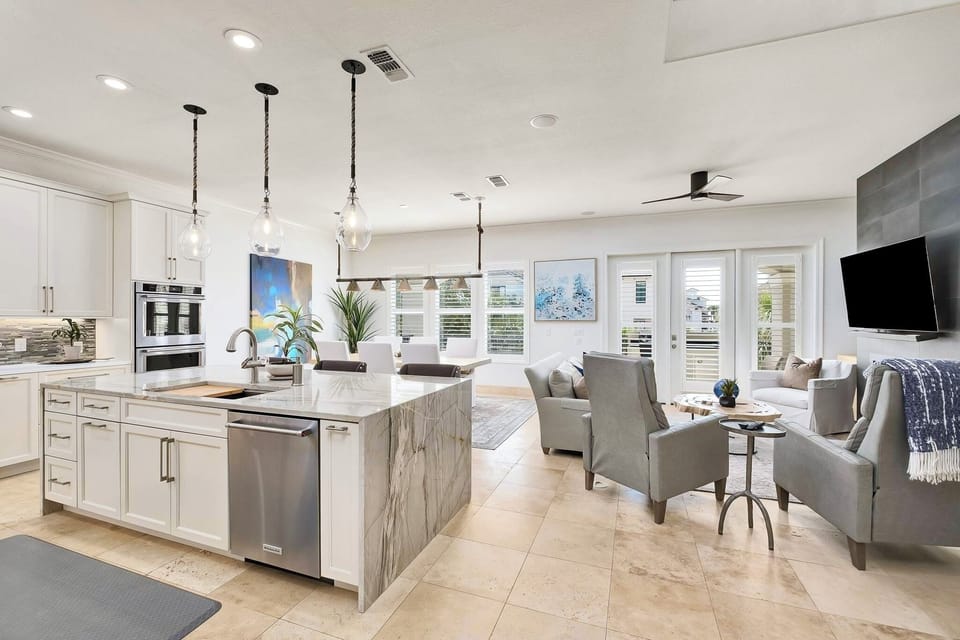2nd Floor - Spacious great room designed for gathering at SunnySide, featuring open-concept living, designer coastal furnishings, abundant natural light, and a modern linear fireplace—perfect for relaxing, entertaining, and unwinding after beach days.
