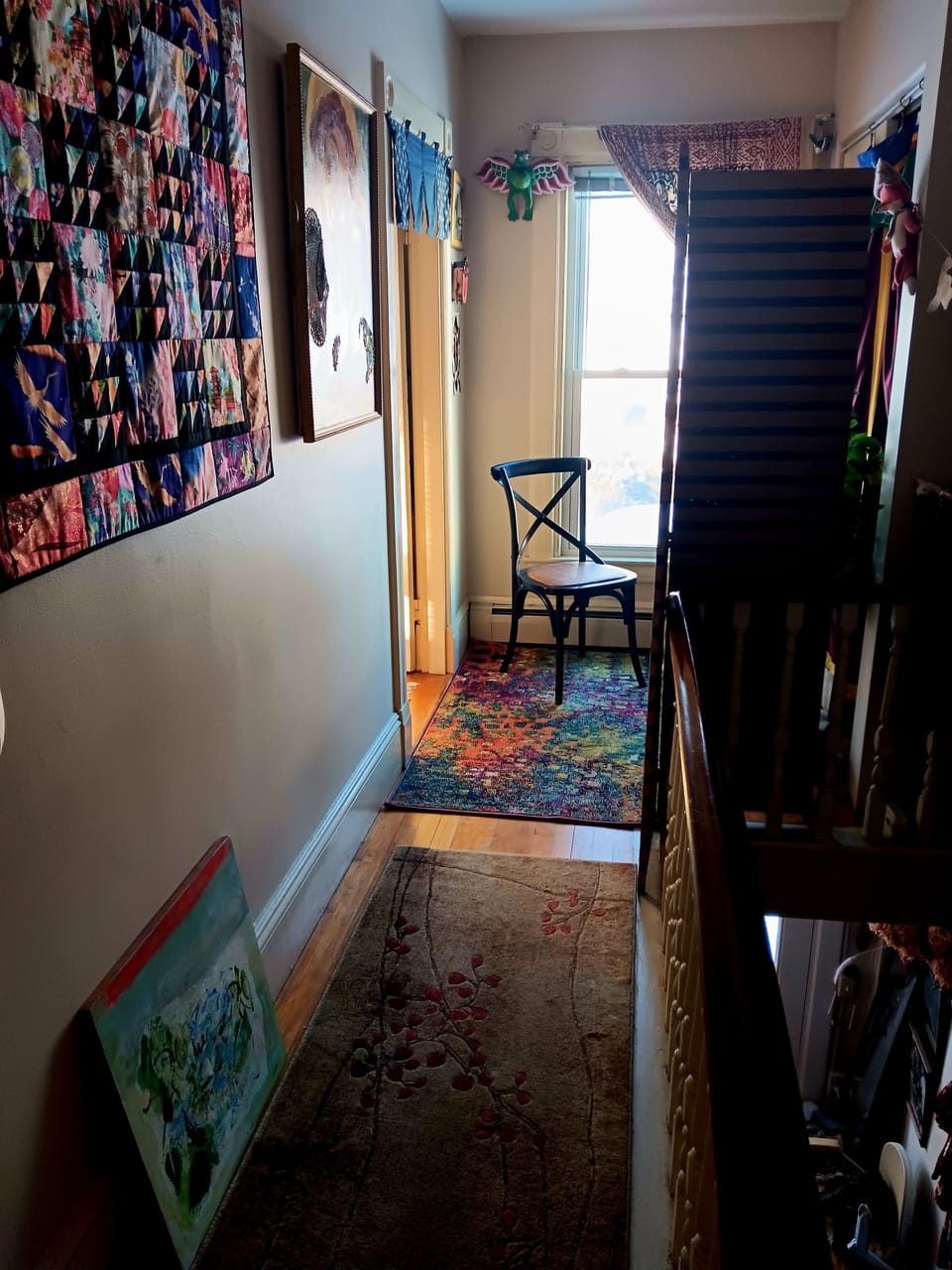 In hallway in front of bedroom, small desk area for writing postcards to friends