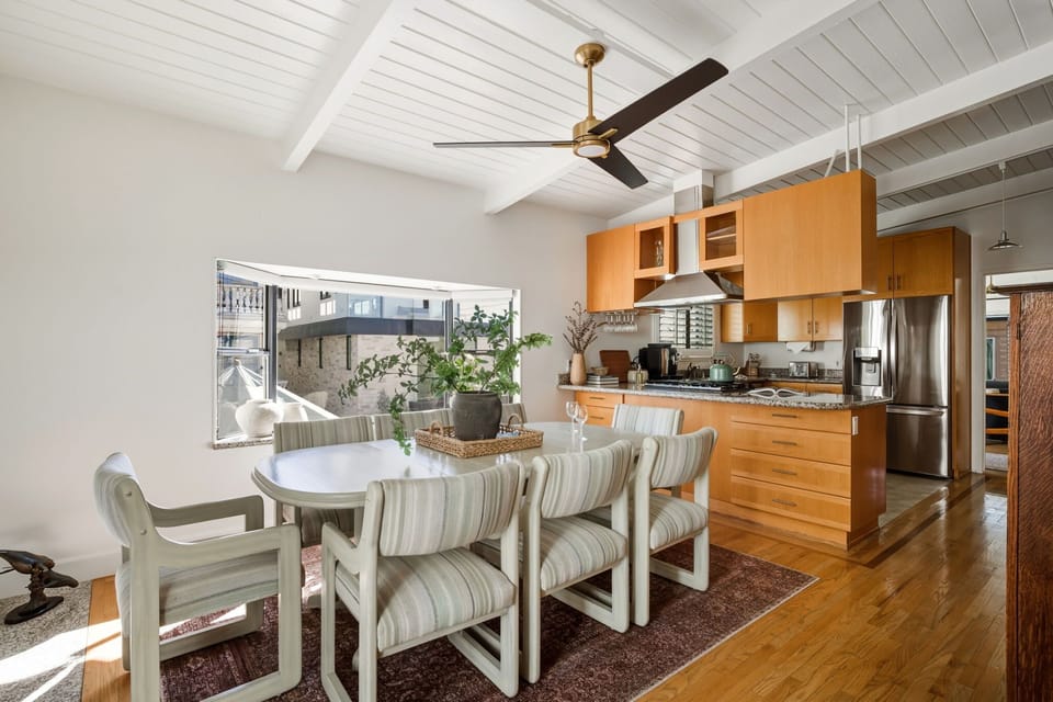 A sunlit dining area flows seamlessly into the kitchen, creating an ideal setting for shared meals.