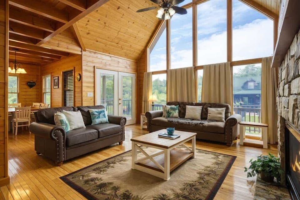 Enjoy your downtime in this comfortable living space featuring two plush couches, soaring ceilings, an indoor fireplace, and TV for movie nights or quiet evenings in.