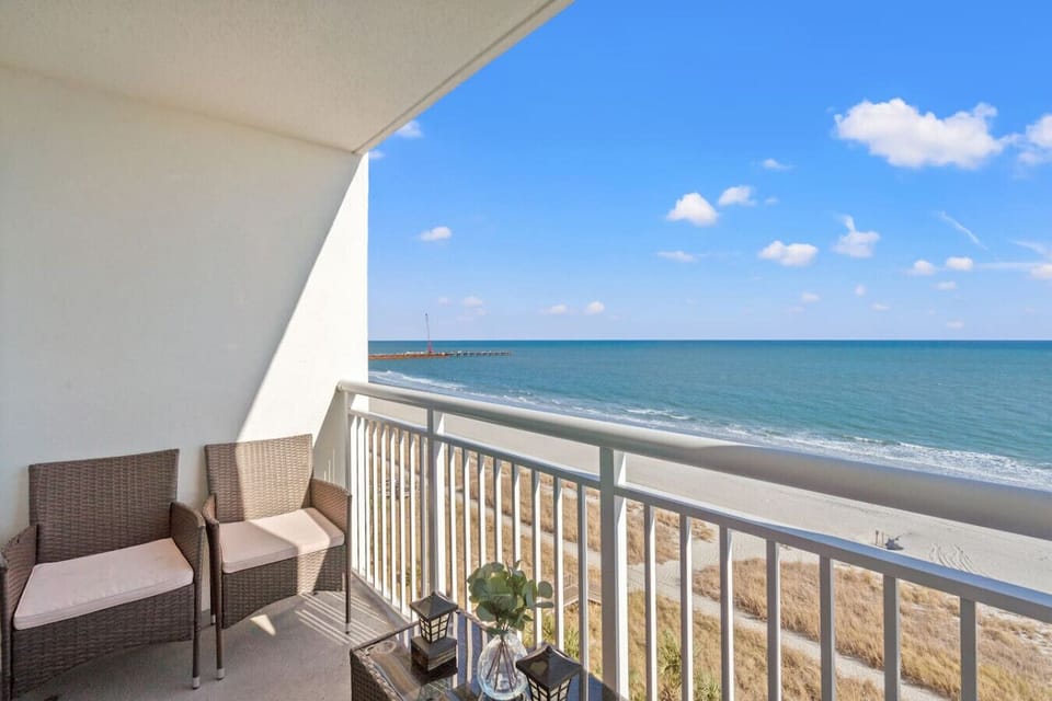 Oceanfront balcony with seating for four and unobstructed sunrise views over the Atlantic. Start your mornings with ocean breezes, coastal sounds, and front-row scenery of the North Myrtle Beach shoreline just steps from your living space.