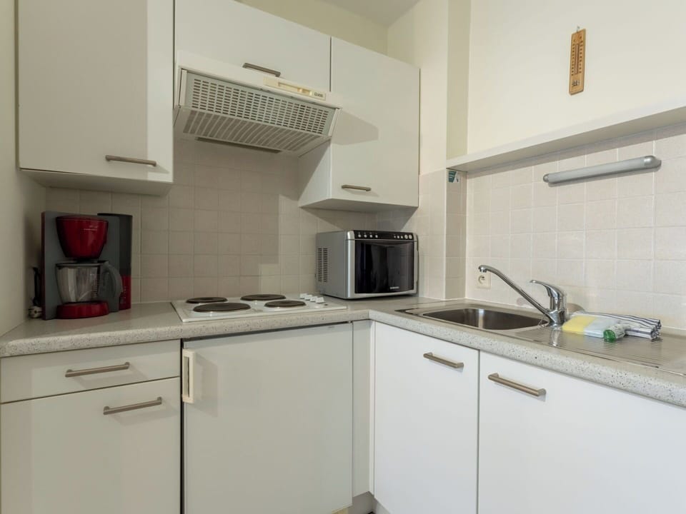Kitchen Appliance, Kitchen, Countertop, Major Appliance, Cabinetry, Kitchen Stove, Flooring, Kitchen Sink, Interior Design, Stove