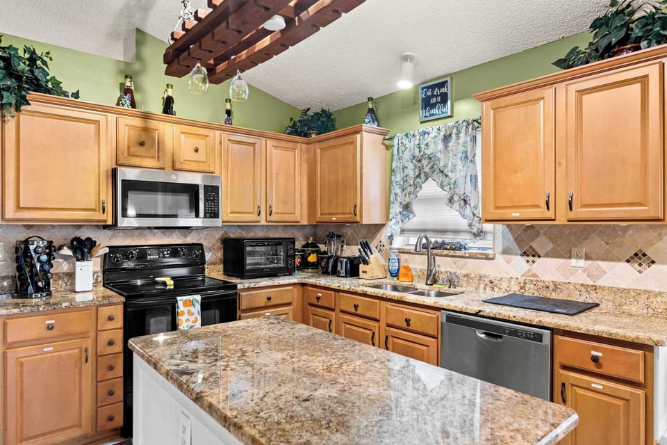 Bright kitchen with granite countertops and wooden cabinetry