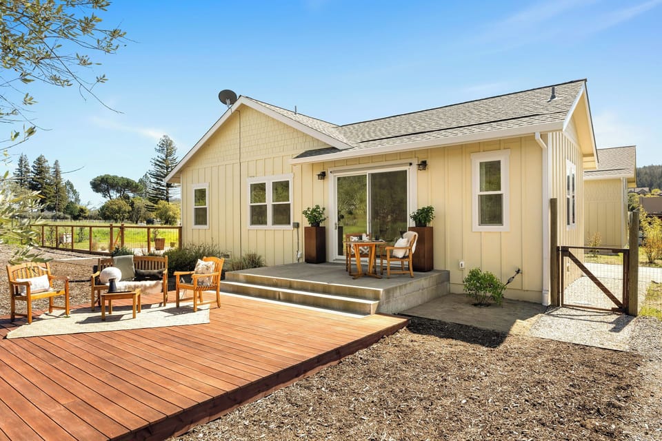Lovely outdoor deck with teak furniture invites guests to relax & dine alfresco.