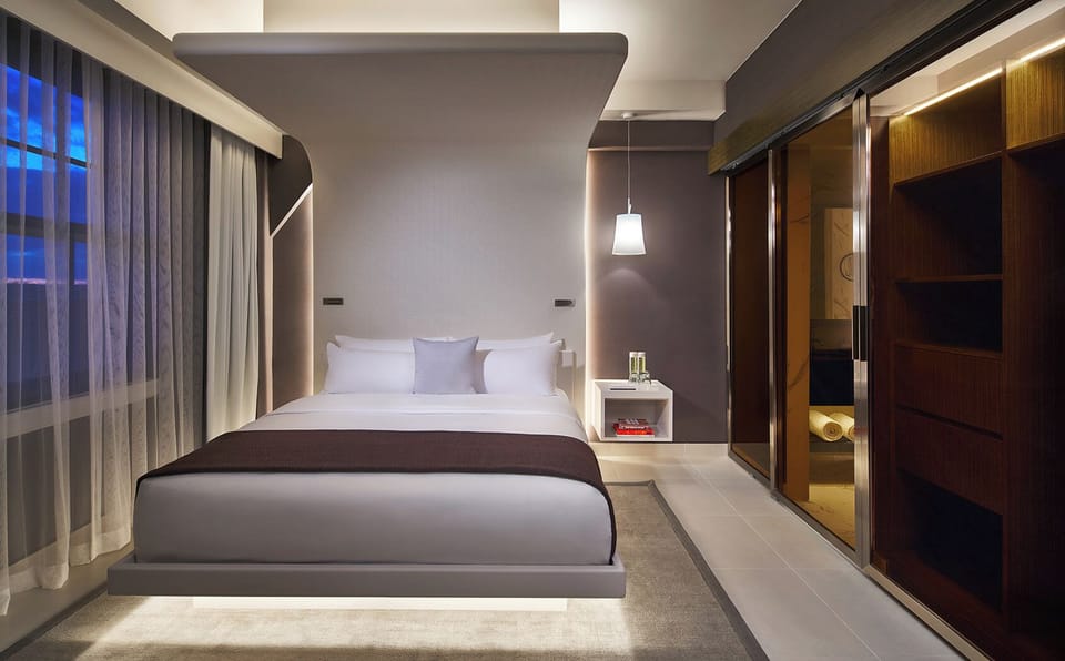 Sink into the plush king bed under warm ambient lighting.