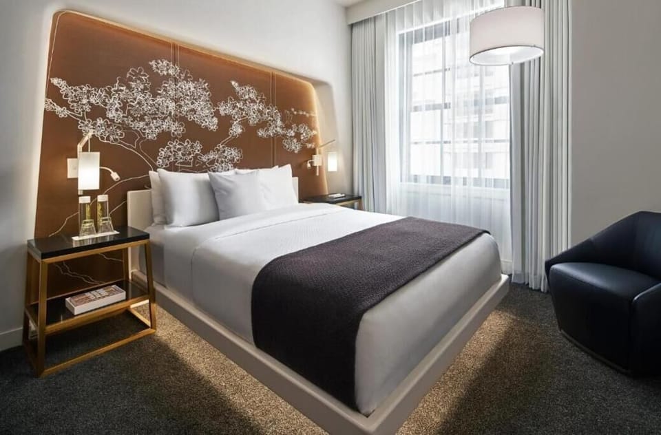 Stretch out in a tranquil room with soft daylight drapes.