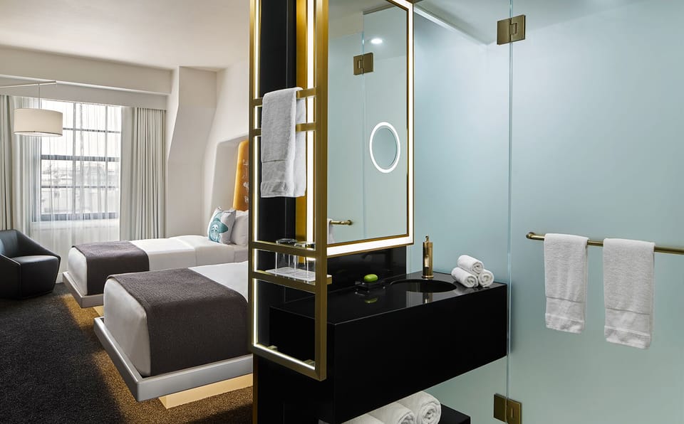 Step into a glass-walled shower with bright, modern finishes.