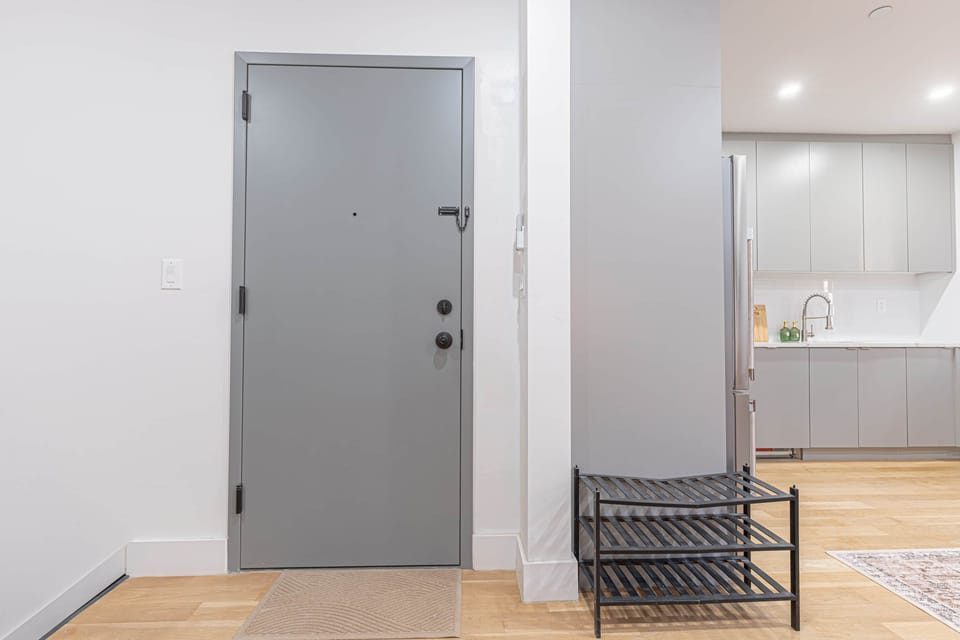 Clean entryway w/ shoe rack—steps from the modern kitchen for easy arrivals.