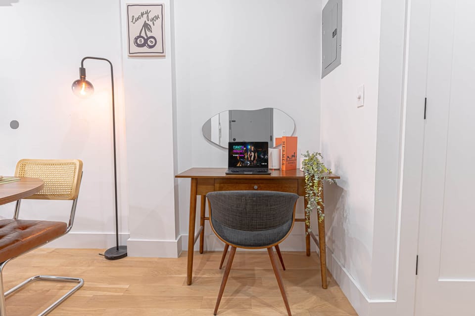 Dedicated work nook w/ desk, comfy chair & warm lighting—great for WFH.