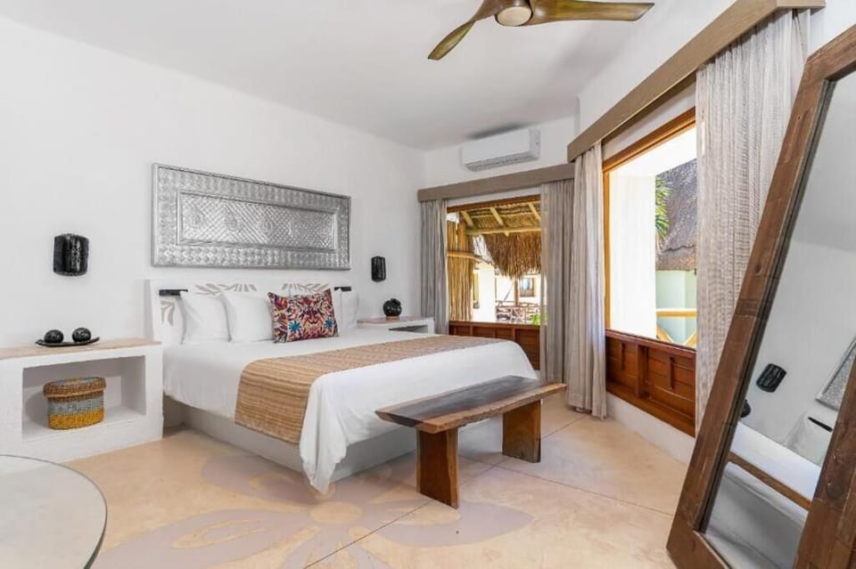 Sink into crisp linens in your airy, coastal retreat.