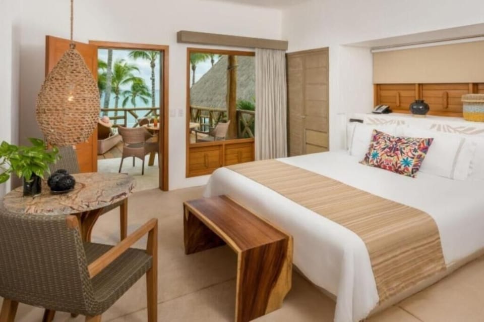 Wake up to ocean air with terrace views from bed.
