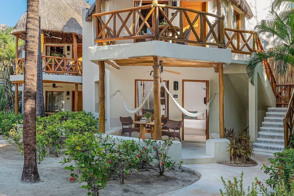 Arrive to a charming villa framed by lush tropical gardens.