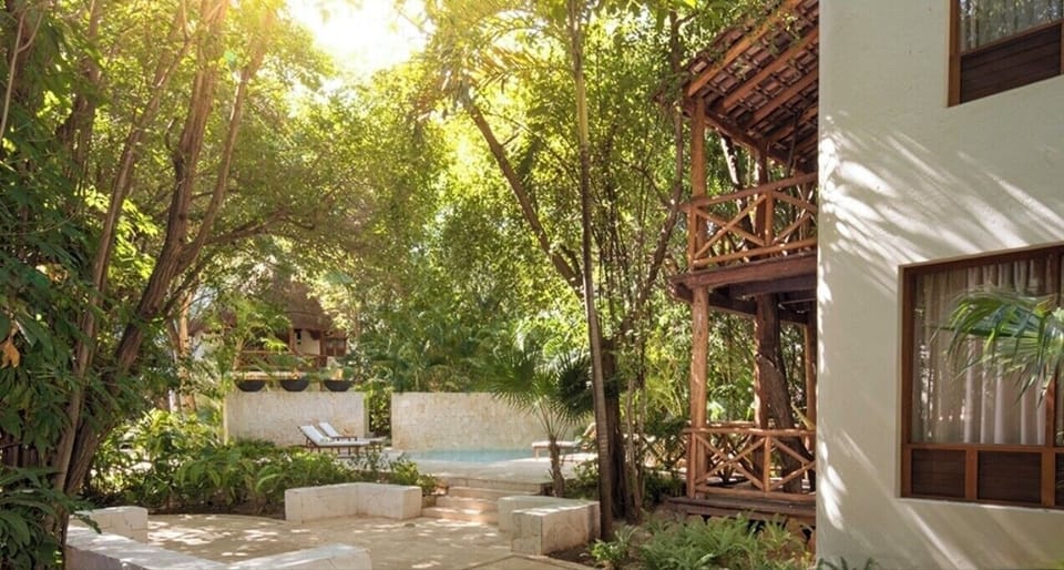 Stroll leafy paths to the tranquil pool hideaway.