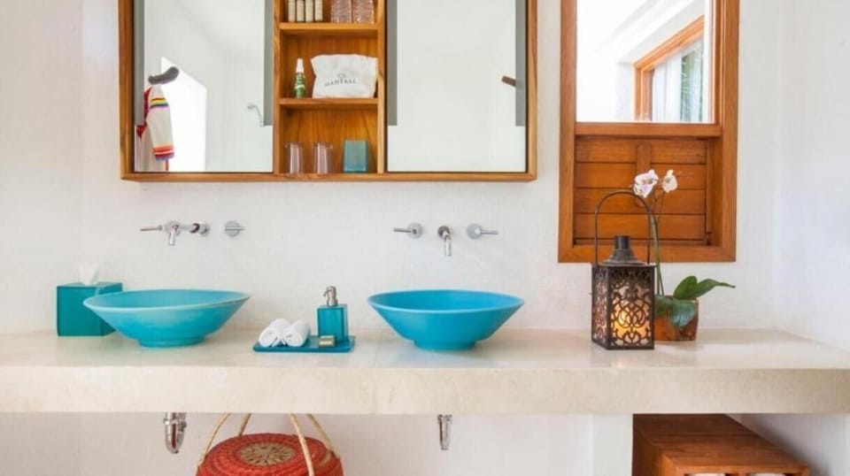 Start mornings at a bright double vanity with soft light.